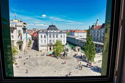 a view of a city from a window at Poet Apartment in Ljubljana