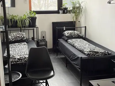 a room with two beds and a chair at INDUSTRIAL ZONE-STUDIO 3 in Ljubljana