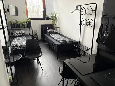 a room with two beds and a couch in it at INDUSTRIAL ZONE-STUDIO 3 in Ljubljana