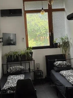 two beds in a room with potted plants at INDUSTRIAL ZONE-STUDIO 3 in Ljubljana