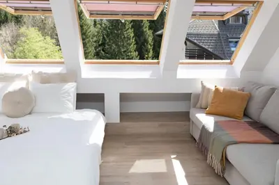 a living room with two couches and two windows at Apartment Lucka, Kranjska Gora in Kranjska Gora