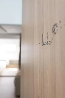 a wooden door with the word luciana written on it at Apartment Lucka, Kranjska Gora in Kranjska Gora