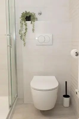 a white bathroom with a toilet and a shower at Apartment Lucka, Kranjska Gora in Kranjska Gora
