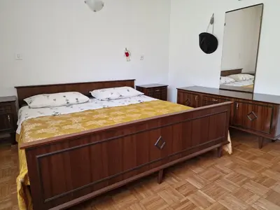 a bedroom with a large bed and a mirror at Apartment Luka at Soča & Koritnica confluence in Bovec