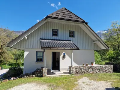 a white house with a gambrel roof at Apartment Luka at Soča & Koritnica confluence in Bovec