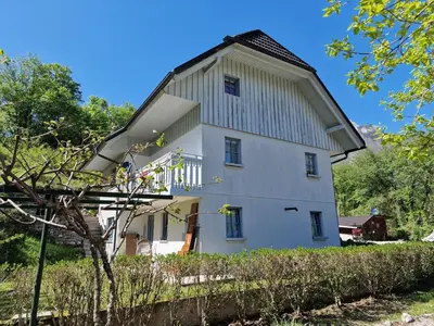 a large white building with a gambrel roof at Apartment Luka at Soča & Koritnica confluence in Bovec