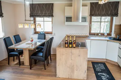 a kitchen and dining room with a table and chairs at Nedelkova Zidanca in Trnovska Vas