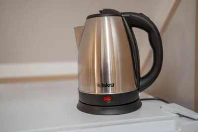 a tea kettle sitting on top of a stove at Nedelkova Zidanca in Trnovska Vas