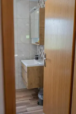 a bathroom with a sink and a mirror at Nedelkova Zidanca in Trnovska Vas