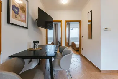 a living room with a dining room table and chairs at House Lenart in Bled