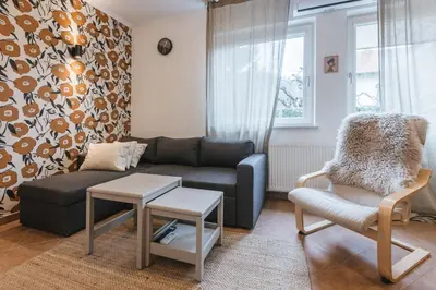 a living room with a couch and a chair at House Lenart in Bled