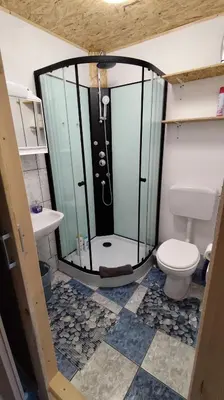 a bathroom with a shower with a toilet and a sink at Domačija Markc in Železniki