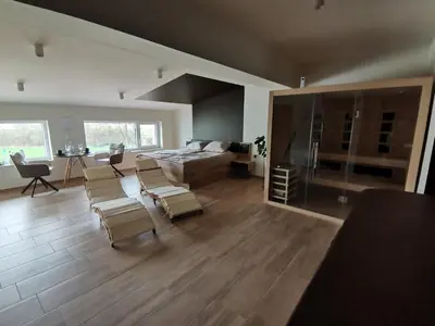 a large living room with a bed and chairs in it at Spa Hera in Šmartno pri Litiji