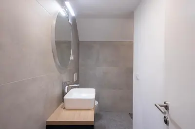 a bathroom with a sink and a mirror at Apartments BB in Bohinj