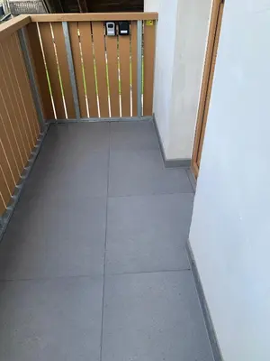 an empty room with a door and a tile floor at Apartments BB in Bohinj
