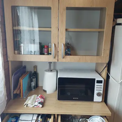 a microwave sitting on a shelf in a kitchen at Brunarica 30 Terme Čatež in Mostec