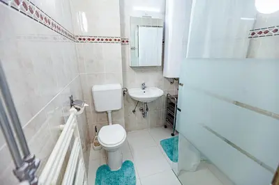a bathroom with a toilet and a sink at Cute tiny house in Ljubljana