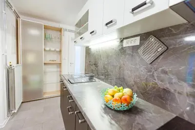 a bowl of fruit on a counter in a kitchen at Cute tiny house in Ljubljana