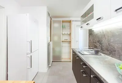 a kitchen with a sink and a refrigerator at Cute tiny house in Ljubljana
