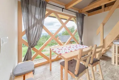 a dining room with a table and a large window at Pr' Končovc in Kranj