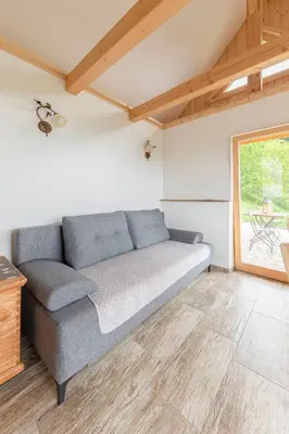 a couch in a living room with a window at Pr' Končovc in Kranj