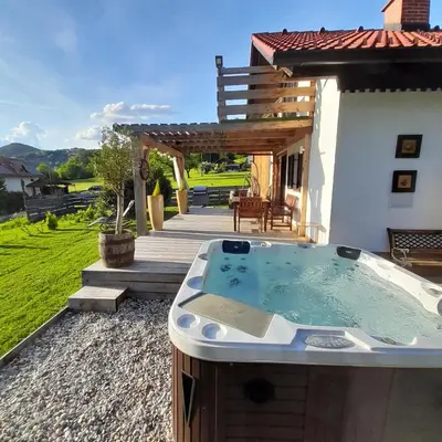 a hot tub in the backyard of a house at Počitniška hiška pri Lipi in Dramlje