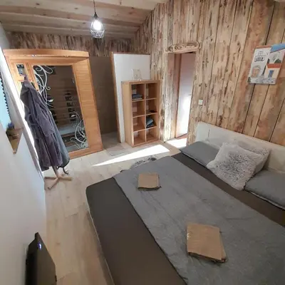 a living room with a large bed and a couch at Počitniška hiška pri Lipi in Dramlje