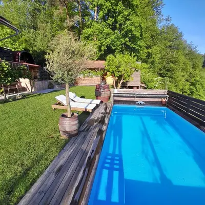 a swimming pool in the backyard of a house at Apartma Lavanda in Dramlje