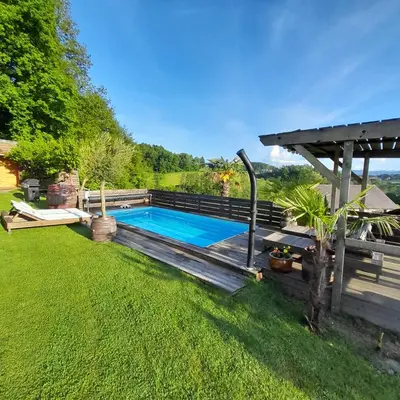 a backyard with a swimming pool and a pergola at Apartma Lavanda in Dramlje