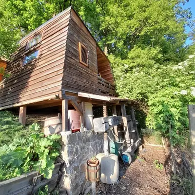 a small house on a stone wall at Glamping pod Hrastom in Dramlje