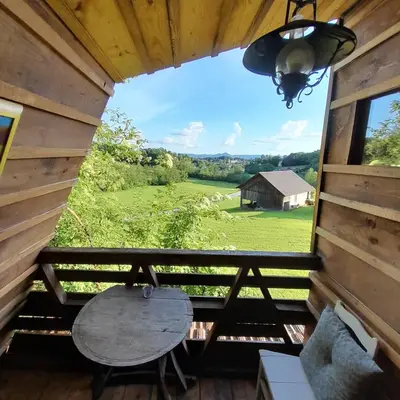 a view from the porch of a cabin with a table at Glamping pod Hrastom in Dramlje