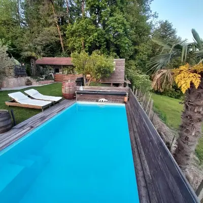a swimming pool in the backyard of a house at Glamping pod Hrastom in Dramlje