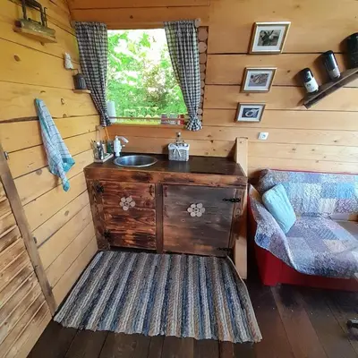 a bathroom with a sink in a log cabin at Glamping pod Hrastom in Dramlje