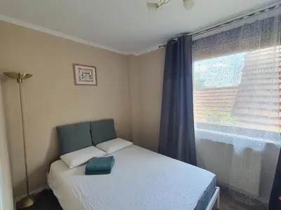 a small bedroom with a bed and a window at DEKO-apartments in Ljubljana