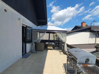 a patio with an umbrella and a table and chairs at DEKO-apartments in Ljubljana