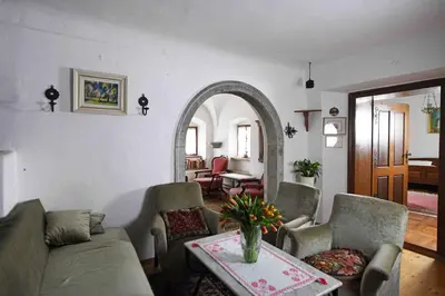 a living room with a couch and chairs and a table at Resort Vidmar - Baroque villa near Bled in Lesce