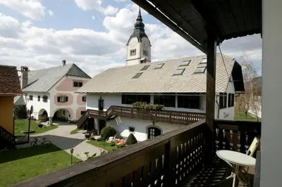 a view from the balcony of a house with a clock tower at Resort Vidmar - Baroque villa near Bled in Lesce