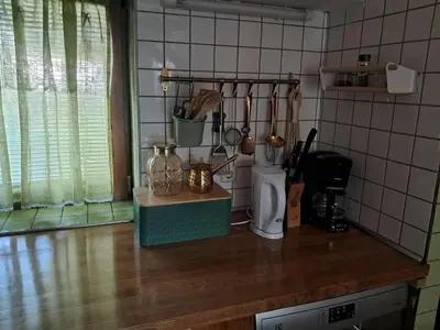 a kitchen counter with utensils on it at Apartment Baci for 4 guests in Ljubljana
