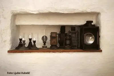 a shelf with a camera and candles on it at Dormouse House in Slovenia in Grahovo