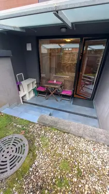 a patio with a table and chairs on a house at MERY Studio in Ljubljana