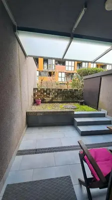 an empty patio with a chair and a building at MERY Studio in Ljubljana