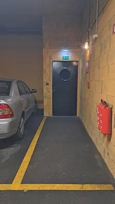 a garage with a car parked in front of a door at MERY Studio in Ljubljana