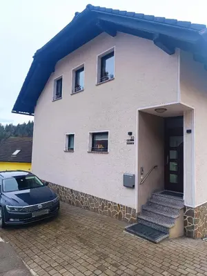 a house with a car parked in front of it at Apartment Break in Rob
