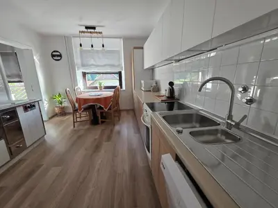 a kitchen with a sink and a table at Apartment Break in Rob