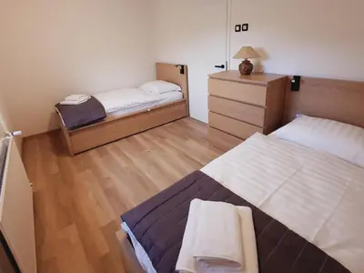 a small bedroom with two beds and a dresser at Apartment Break in Rob