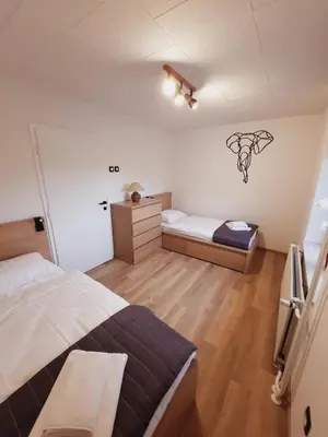 a bedroom with a bed and a bench in it at Apartment Break in Rob