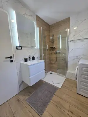a bathroom with a white sink and a shower at Apartment Break in Rob