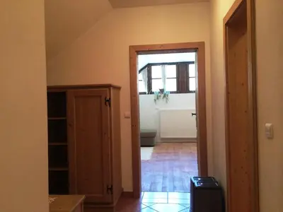 a hallway with a door leading into a room at Apartments Pod macesnovo streho in Solčava