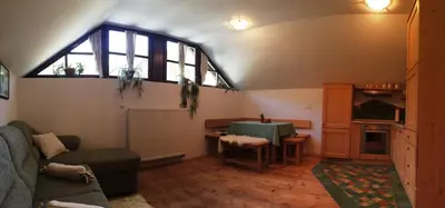 a living room with a couch and a table at Apartments Pod macesnovo streho in Solčava