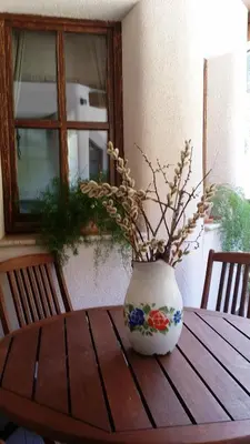 a vase sitting on top of a wooden table at Apartments Pod macesnovo streho in Solčava